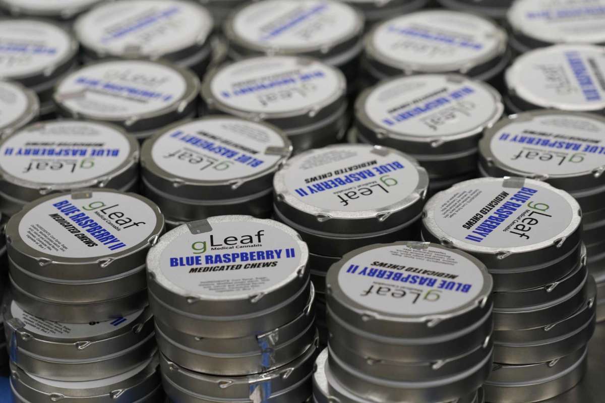 Tins of Green Leaf medicated chews are stacked up at the company's plant in Richmond, Va., Thursday, June 17, 2021. The date for legalizing marijuana possession is drawing near in Virginia, and advocacy groups have been flooded with calls from people trying to understand exactly what becomes legal in July. (AP Photo/Steve Helber)