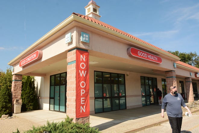 Medical marijuana patient Ed Messier, 46, of Willimantic, leaves Fine Fettle medical marijuana dispensary in Willimantic after making a purchase Wednesday.