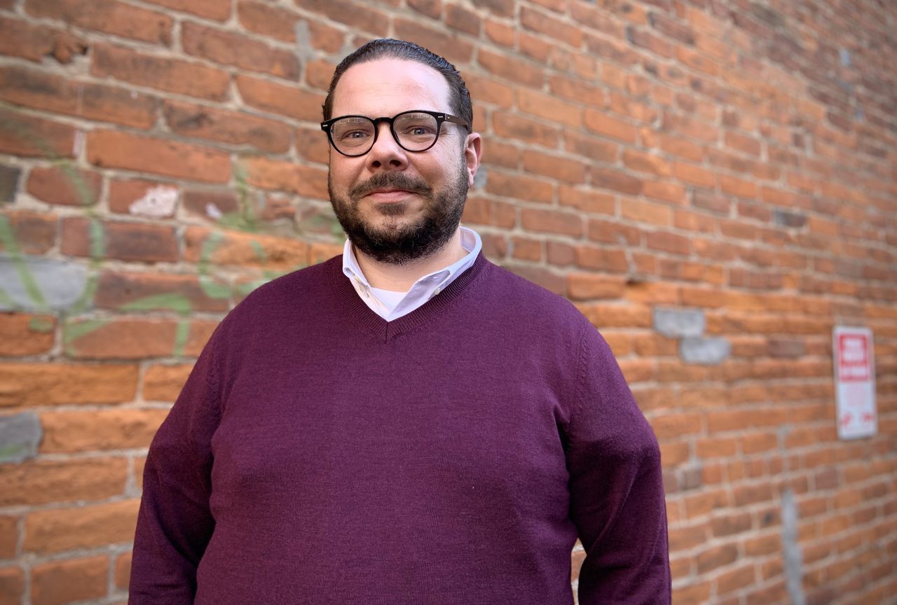 Joe Rossi of Park Strategies poses for a photo outside his office in downtown Syracuse, NY.
